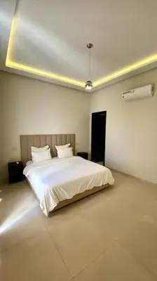 a bedroom with a white bed in a room at Villa P1 avec Piscine Chauffée in Marrakech