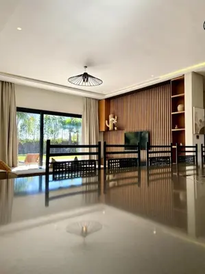 a living room with a table and a living room with a couch at Villa P1 avec Piscine Chauffée in Marrakech