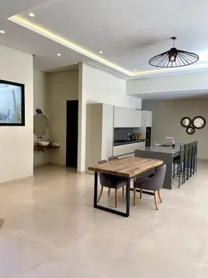 a dining room and kitchen with a table and chairs at Villa P1 avec Piscine Chauffée in Marrakech