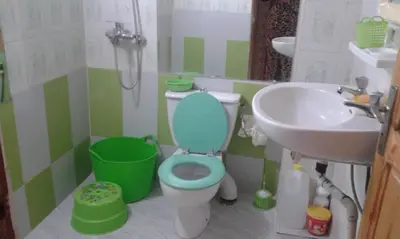 a bathroom with a blue toilet and a sink at fes in Fès