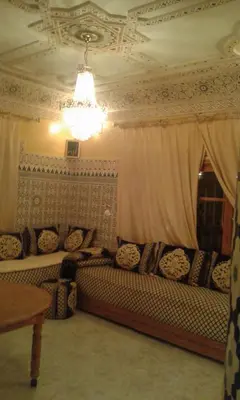 a living room with a couch and a window at fes in Fès