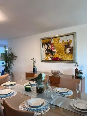 a dining room with a table with plates and glasses at Ghali Appart in Fès