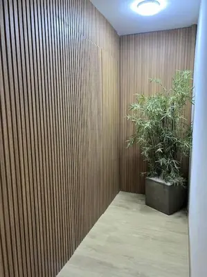 a room with a wooden wall with a potted plant at Ghali Appart in Fès
