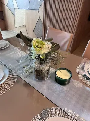 a table with a vase with flowers on it at Ghali Appart in Fès