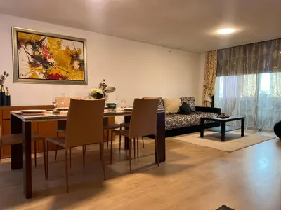 a living room with a table and chairs and a couch at Ghali Appart in Fès