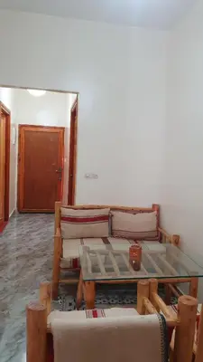 a living room with a table and a couch at Tayda Guest House in Azilal