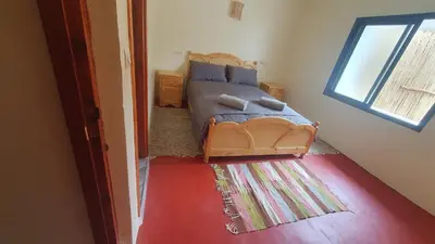 a bedroom with a bed and a window at Tayda Guest House in Azilal