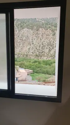 a view of a mountain from a window at Tayda Guest House in Azilal