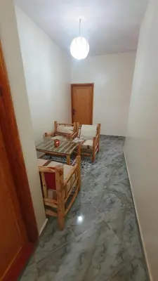 a room with two beds and a table at Tayda Guest House in Azilal