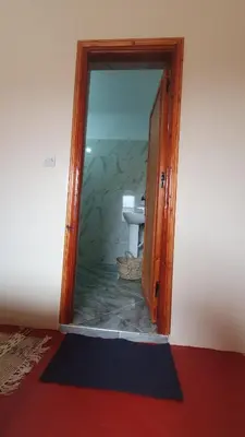 a doorway to a bathroom with a toilet in a room at Tayda Guest House in Azilal