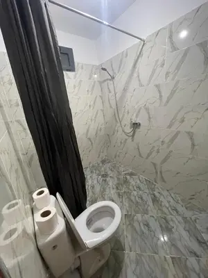 a bathroom with a toilet and two rolls of toilet paper at Tayda Guest House in Azilal