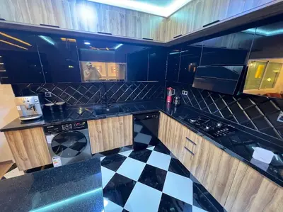 a kitchen with a black and white checkered floor at Appartement Fes Sami Haut Standing in Fès