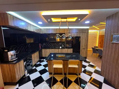 a kitchen with a black and white checkered floor at Appartement Fes Sami Haut Standing in Fès