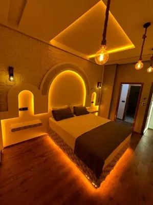 a bedroom with a large bed with lights on it at Appartement Fes Sami Haut Standing in Fès