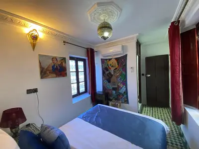 a bedroom with a blue tub in a room at Dar Zerbtana Chambre chaoune in Fès