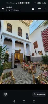 a picture of a living room with tables and chairs at Dar Zarbtana Chambre Essaouira in Fès