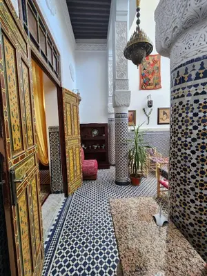 a room with an entrance with a door and a floor with tiles at Dar Zarbtana Chambre Hiba in Fès
