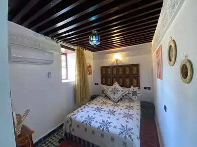 a bedroom with a bed in a room at Dar Zarbtana Chambre RADIA in Fès