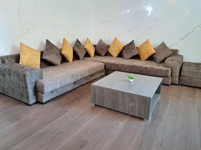 a living room with two couches and a coffee table at Appartement Jasmine Atlas Center in Fès