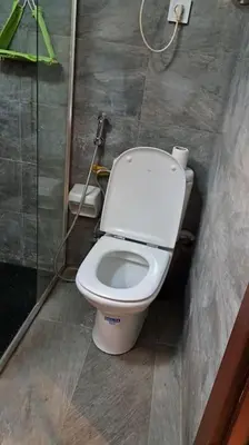 a bathroom with a white toilet in a stall at Appartement Jasmine Atlas Center in Fès