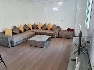 a living room with a couch and a table at Appartement Jasmine Atlas Center in Fès