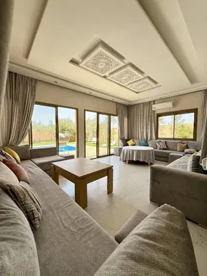 a living room with a couch and a table at The Atlas View and Elegant Villa Marrakech in Marrakech