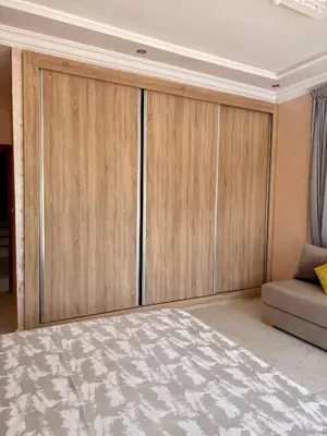 a room with wooden cabinets and a couch at The Atlas View and Elegant Villa Marrakech in Marrakech