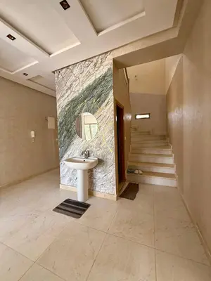 a bathroom with a sink and a painting on the wall at The Atlas View and Elegant Villa Marrakech in Marrakech