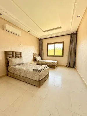 a large bedroom with two beds and a window at The Atlas View and Elegant Villa Marrakech in Marrakech