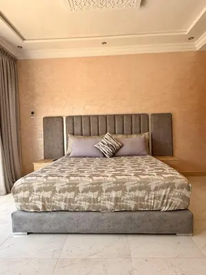 a bedroom with a large bed with a large bed sidx sidx sidx at The Atlas View and Elegant Villa Marrakech in Marrakech