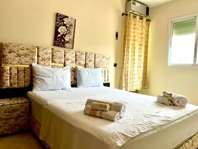 a bedroom with a large bed with towels on it at Appart Hotel Fes - Joud Families & Travelers in Fès