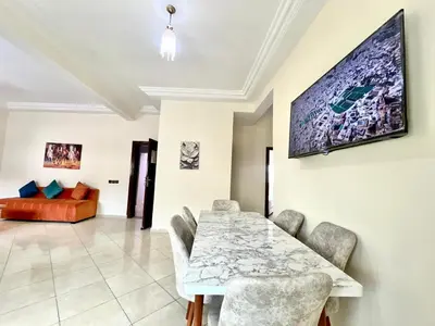 a dining room with a table and a couch at Appart Hotel Fes - Joud Families & Travelers in Fès
