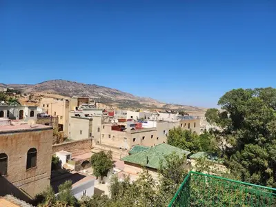 a view of a city with mountains in the background at Dar Zarbtana Chambre Marrakech in Fès
