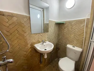 a bathroom with a toilet and a sink at Dar Zarbtana Chambre Marrakech in Fès
