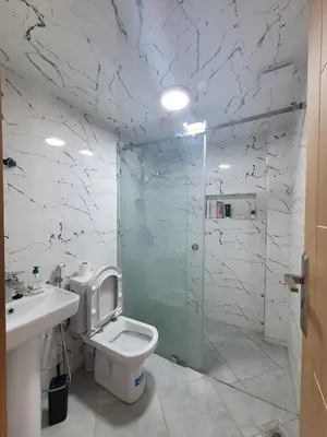 a bathroom with a toilet and a glass shower at Bella nova in Azrou