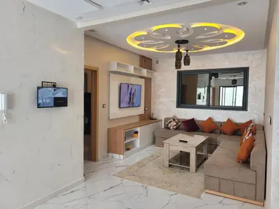 a living room with a couch and a tv at Bella nova in Azrou