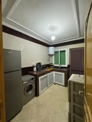 a kitchen with a washing machine and a washer at Mohammed zerrifi in Fès