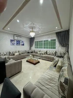 a large living room with couches and a table at Mohammed zerrifi in Fès