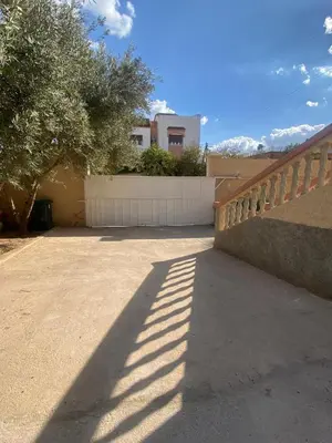 a shadow of a fence next to a driveway at Villa appartement jardin et piscine in Meknès