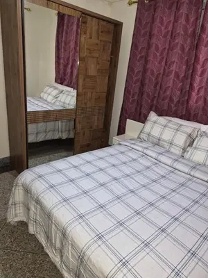 a bedroom with a bed and a mirror at Villa appartement jardin et piscine in Meknès