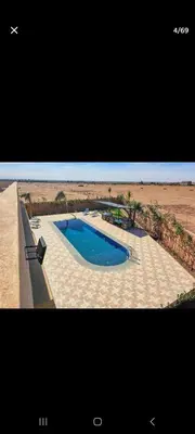a picture of a swimming pool in the middle of the desert at Zaouiet ben sassi in Marrakech