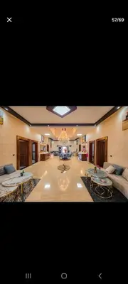 a large living room with two tables and a couch at Zaouiet ben sassi in Marrakech