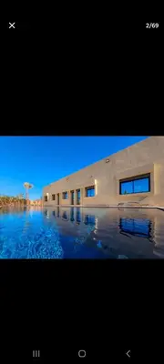 a picture of a building with water in front of it at Zaouiet ben sassi in Marrakech