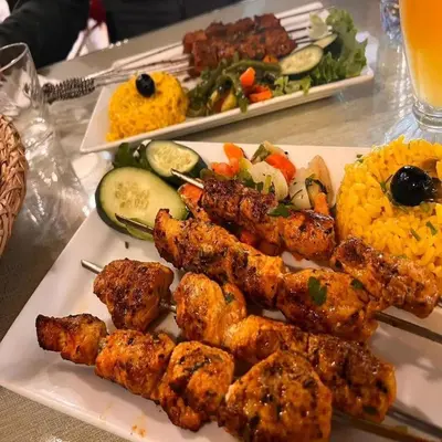 a plate of food with meat and vegetables on a table at Chic Boheme Camp in Merzouga