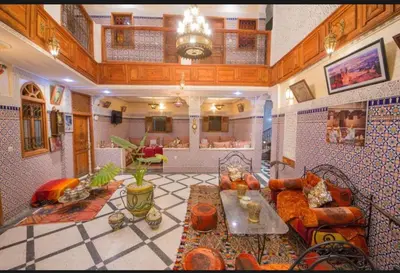 a living room with a couch and a table at Riad Maison Haddaji Fez in Fès