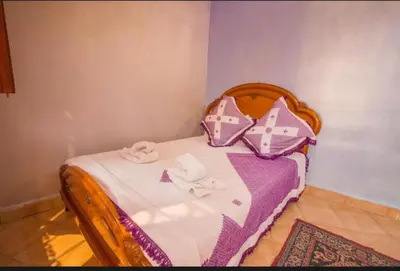 a small bed with towels and pillows on it at Riad Maison Haddaji Fez in Fès