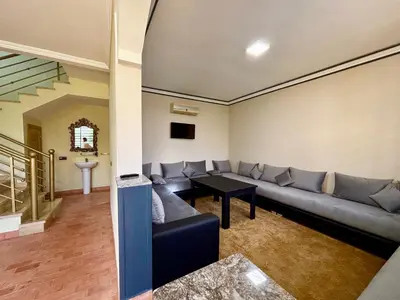 a living room with a couch and a table at Cabanne ourika in Marrakech