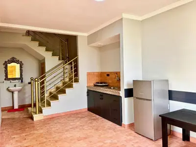 a kitchen with a staircase and a refrigerator at Cabanne ourika in Marrakech