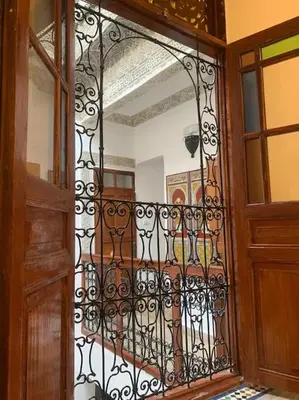 an open door to a room with a iron gate at Dar ZaZ in Fès
