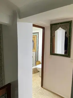 a bathroom with a mirror and a toilet at Dar ZaZ in Fès